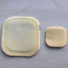 Adhesive foam wound dressing
