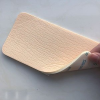Adhesive foam wound dressing
